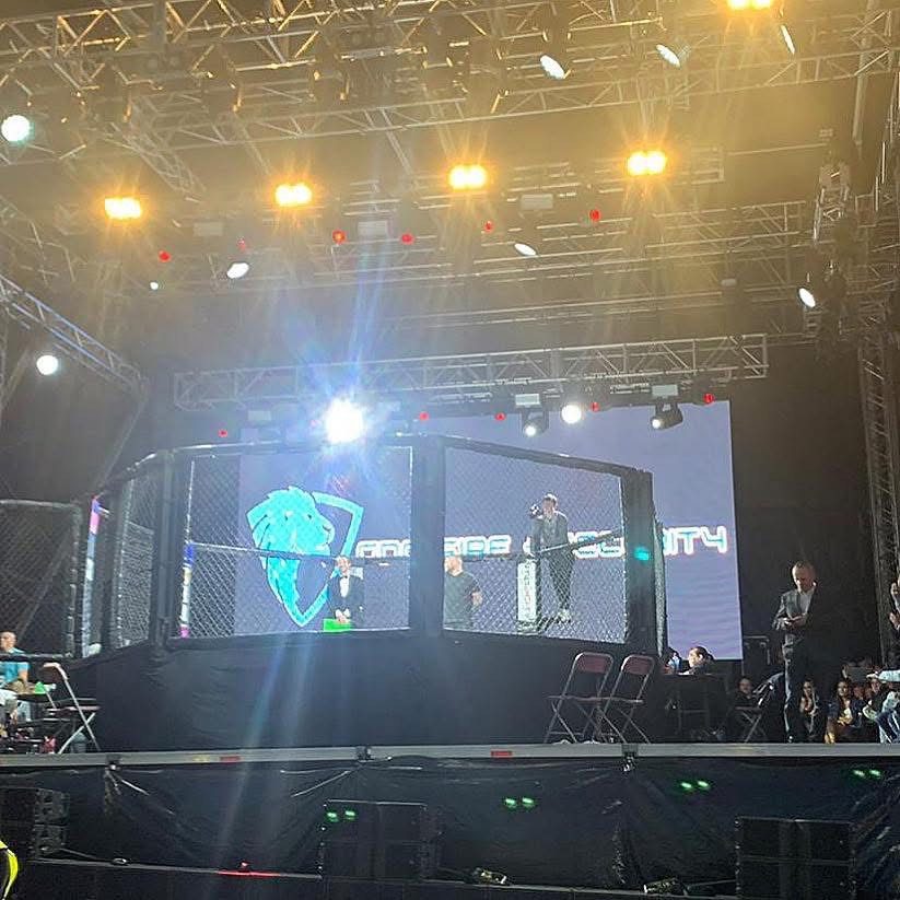 GDC Fire & Security branding on the cage at a Cage Conflict MMA event